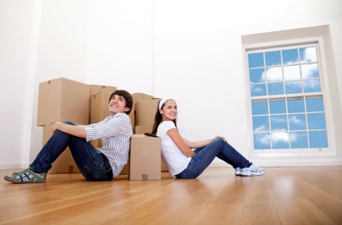 Movers handling furniture and boxes during a home relocation