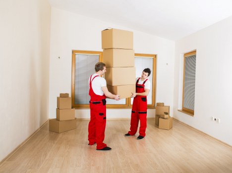 Loading boxes into a moving truck in Claphampark